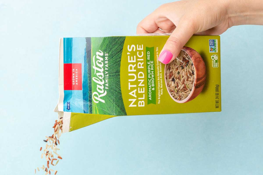 pouring nature's blend rice with white blue background