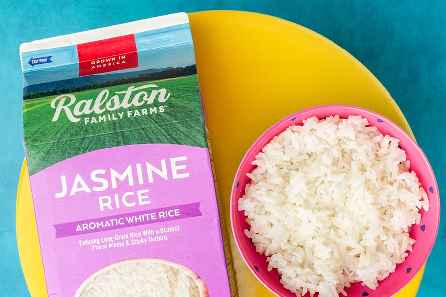 bright image of Jasmine Rice package and rice bowl on yellow plate