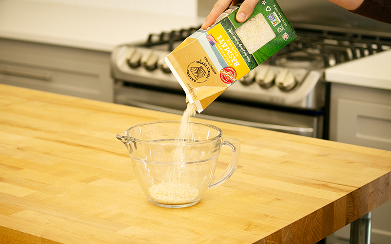pouring rice into measure cup