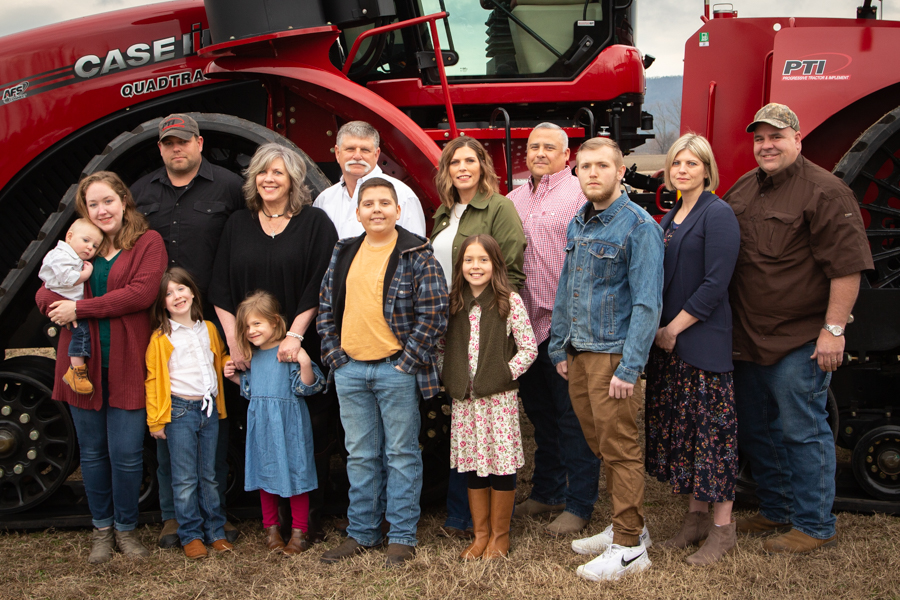 image of ralston family in front of red tractor